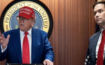 donald Trump wearing red Make America Great Again cap speaking at podium with Marco Rubio
