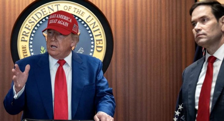 donald Trump wearing red Make America Great Again cap speaking at podium with Marco Rubio