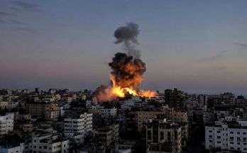 massive explosion engulfs Gaza City buildings at dusk during Israeli airstrike